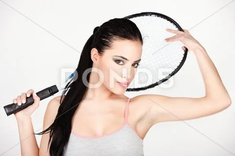 Pretty woman with tennis racket Stock Photos