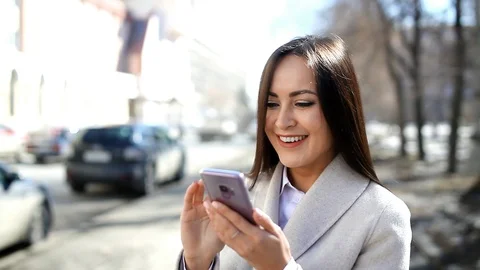 Pretty woman using her smartphone outdoors Stock Footage 88218110