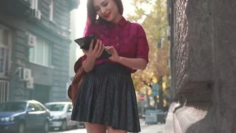 Pretty woman using tablet pc in the street. smiling girl flirting on camera Stock Footage 170372736