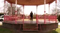 Pretty woman walks away from bandstand HD Footage