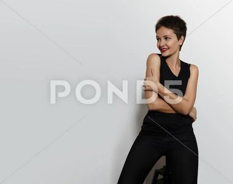 Pretty woman on a white back. Short haircut Stock Photos