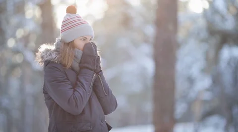 Pretty woman in winter hat enjoys the snow Video stock 59606231