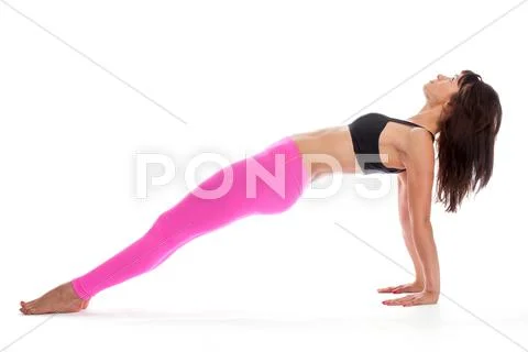Pretty woman in yoga pose - reverse plank position. Stock Photos