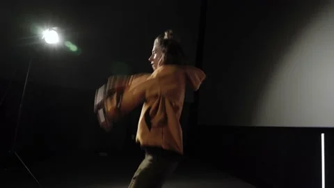 Pretty young actress performing expressive dance elements against black back Video stock 186487544