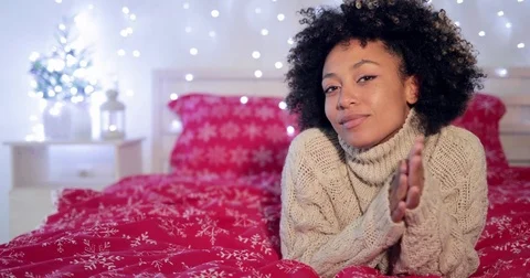 Pretty young African woman in a festive bedroom Stock Footage