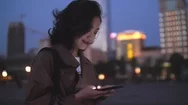 Pretty Young Asian Woman Using Mobile Phone In The City Street At Night, 4K Stock Footage