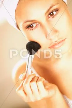 Pretty young brunette girl doing morning makeup Stock Photos