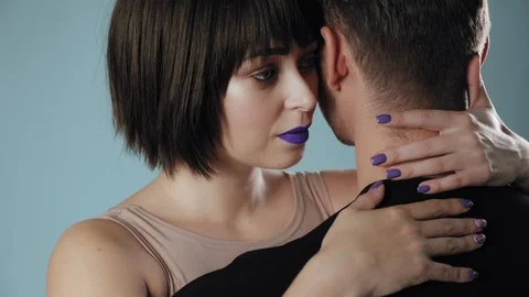 Pretty young couple posing on studio background Stock Footage 96487860