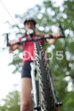 Pretty young female biker outddors on her mountain bike (shallow Stock Photos