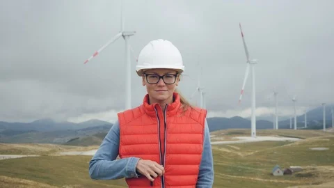Pretty young female engineer in red vest rejoices at launch of complex Stock Footage 117573492
