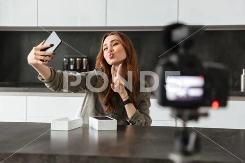 Pretty young girl recording video blog episode Stock Photos