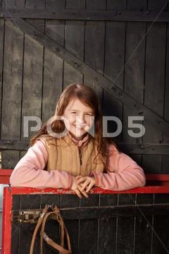 Pretty young girl in the stable Stock Photos