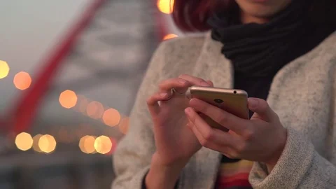 Pretty young girl using smart phone mobile in the city at night Stock Footage 79814023
