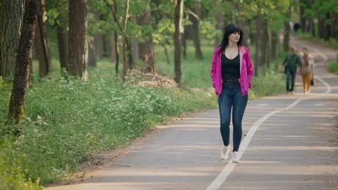 A pretty young girl walks in the Park Stock Footage