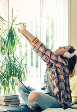Pretty young lady streching while using laptop Stock Photos