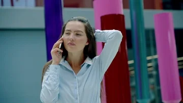 Pretty , young lady trying to get through the smartphone to her business partner Stock-Footage 86029922
