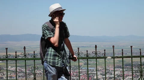 Pretty young man talking on smart phone, vacation, traveling, panorama view Stock Footage 40533784