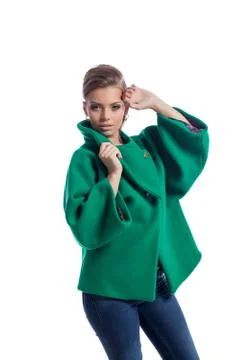 Pretty young model posing in green coat, close-up Stock Photos