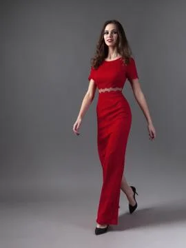 Pretty young sexy model female with dark hair in amazing red dress Stock-Fotos
