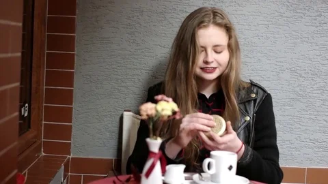 Pretty, Young Smiling Girl Checking Her Appearance in Mirror Sitting in Cafe Stock Footage 73548495