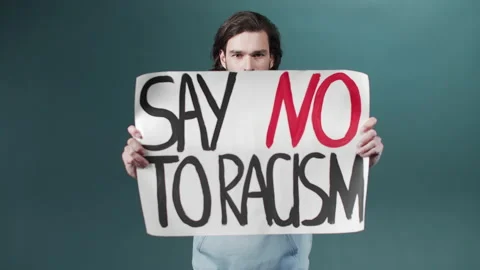 A pretty young white man in a blue hoodie calls on everyone to stop racism Stock Footage 170798458