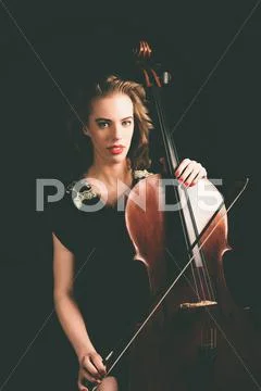 Pretty Young Woman Holding a Cello Instrument Stock Photos