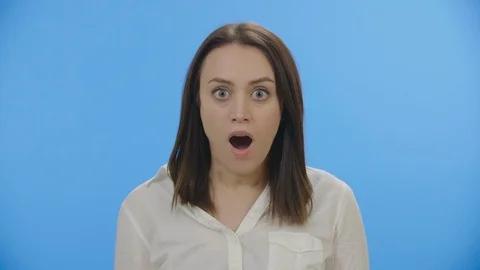 Pretty young woman looking at camera in open-mouthed amazement 4K Stock Footage 88398786