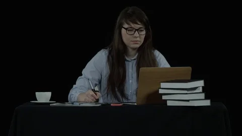 Pretty young woman makes work notes Stock Footage 77646053