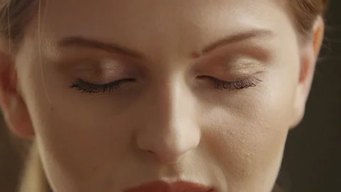 Pretty Young Woman Opening and Closing her Eyes Stock Footage 113682616