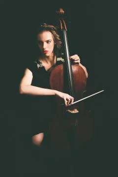 Pretty young woman playing the cello Stock Photos