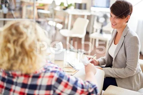 Pretty young woman talking to her patient Stock Photos