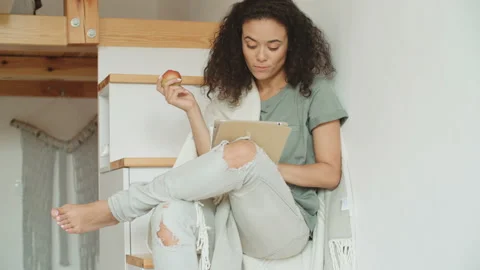 Pretty young woman using digital tablet at home. Stock Footage 100596415