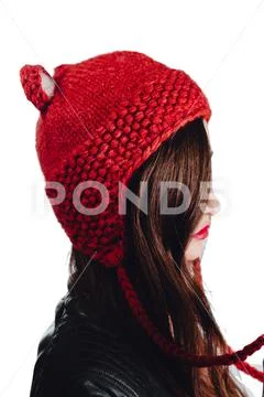Pretty young woman wearing a hand knitted red hat on white background. Isolated Stock Photos