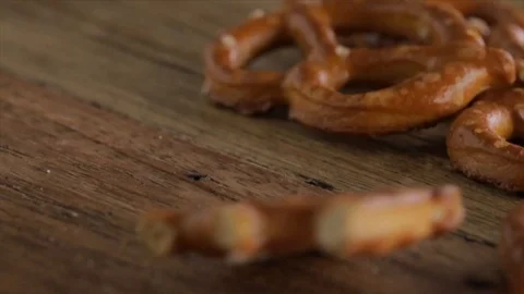 Pretzel Falling onto a Wooden Table Closeup Stock Footage 99138166