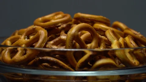 Pretzel salted in rotation. Close up. Studio shot. Grey background. Stock Footage 102626314