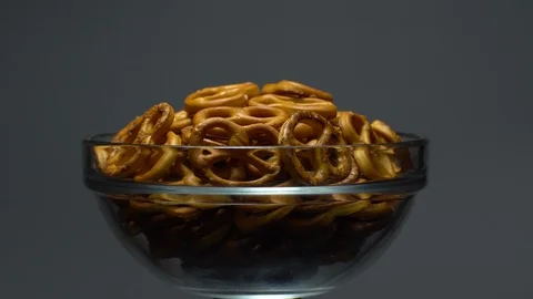 Pretzel salted in rotation. Close up. Studio shot. Grey background. Stock Footage 102626509