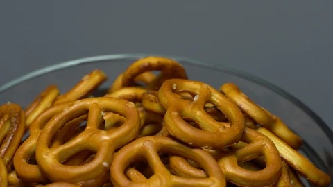 Pretzel salted in rotation. Close up. Studio shot. Grey background. Stock Footage 102626699