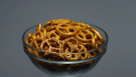 Pretzel salted in rotation. Close up. Studio shot. Grey background. Stock Footage 102626769