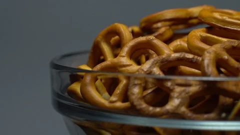 Pretzel salted in rotation. Close up. Studio shot. Grey background. Stock Footage 102626910
