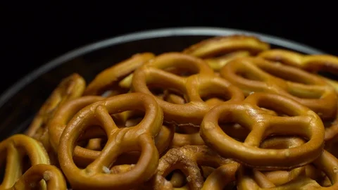 Pretzel salted in rotation. Close up. Studio shot. Black background. Stock Footage 102627088