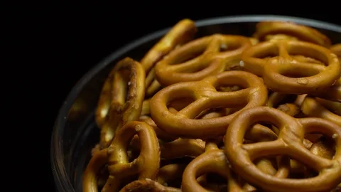 Pretzel salted in rotation. Close up. Studio shot. Black background. Stock Footage 102627153