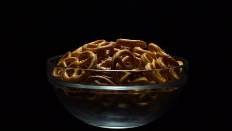 Pretzel salted in rotation. Close up. Studio shot. Black background. Stock Footage 102627301