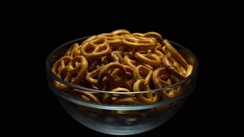 Pretzel salted in rotation. Close up. Studio shot. Black background. Stock Footage 102627456