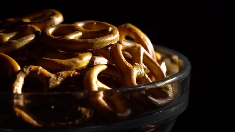 Pretzel salted in rotation. Close up. Studio shot. Black background. Stock Footage 102627655