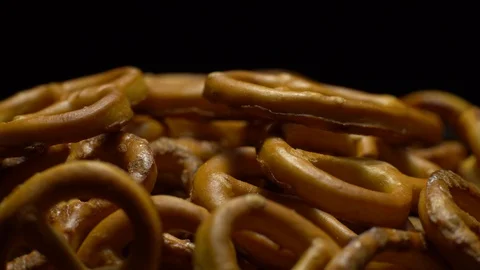 Pretzel salted in rotation. Close up. Studio shot. Black background. Stock Footage 102627715