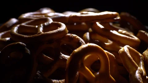 Pretzel salted in rotation. Close up. Studio shot. Black background. Stock Footage 102627824
