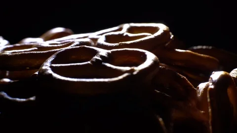 Pretzel salted in rotation. Close up. Studio shot. Black background. Stock Footage 102627867