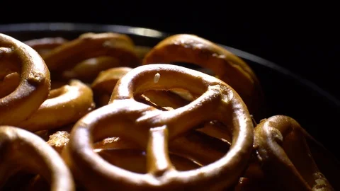 Pretzel salted in rotation. Close up. Studio shot. Black background. Stock Footage 102627899