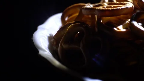 Pretzel salted in rotation. Close up. Studio shot. Black background. Stock Footage 102664197