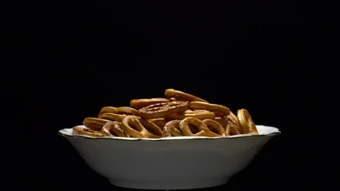 Pretzel salted in rotation. Close up. Studio shot. Black background. Stock Footage 102664462
